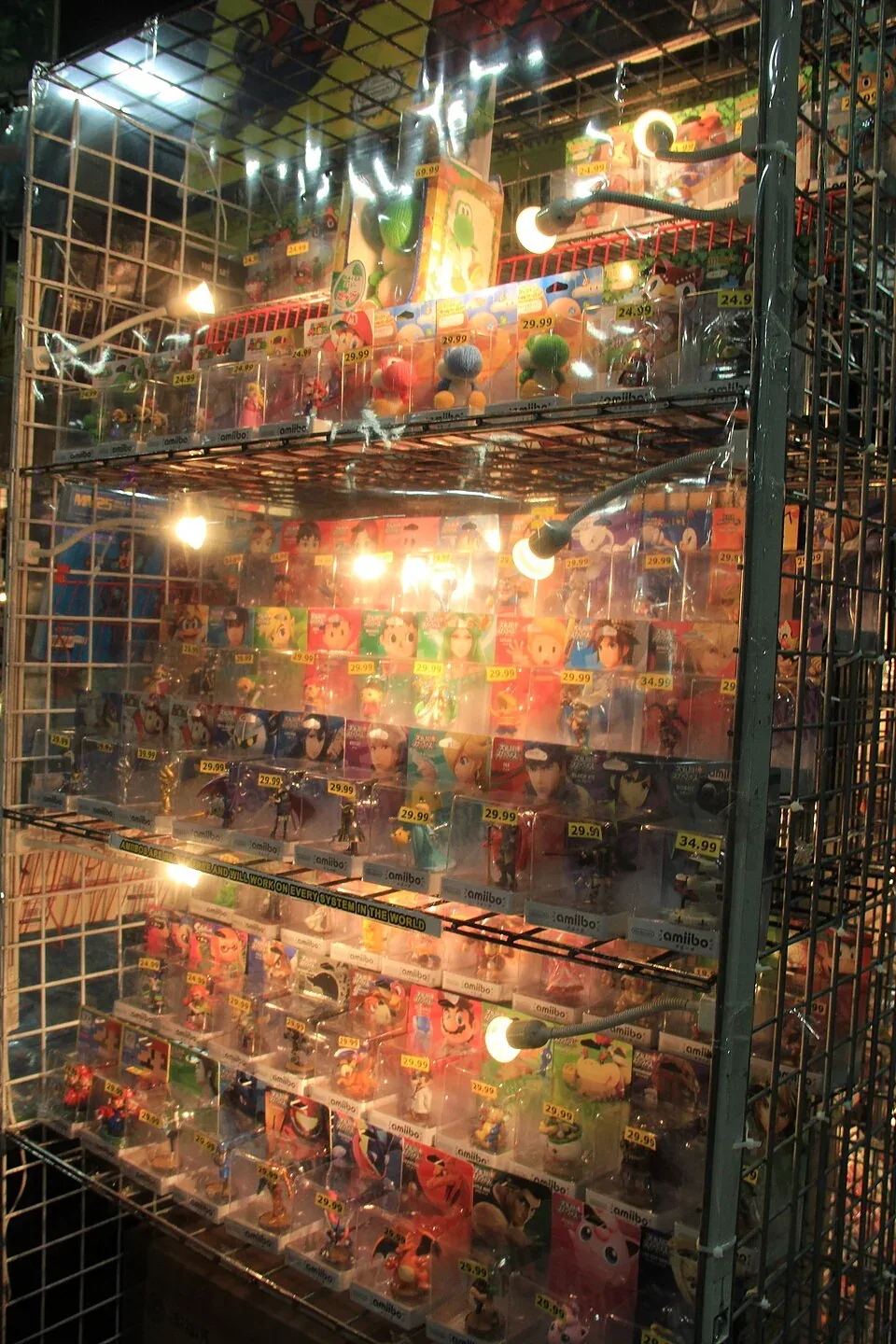 Carded amiibo displayed on retail shelving at PAX South 2016, with original packages, price labels and bright lamps retained in view