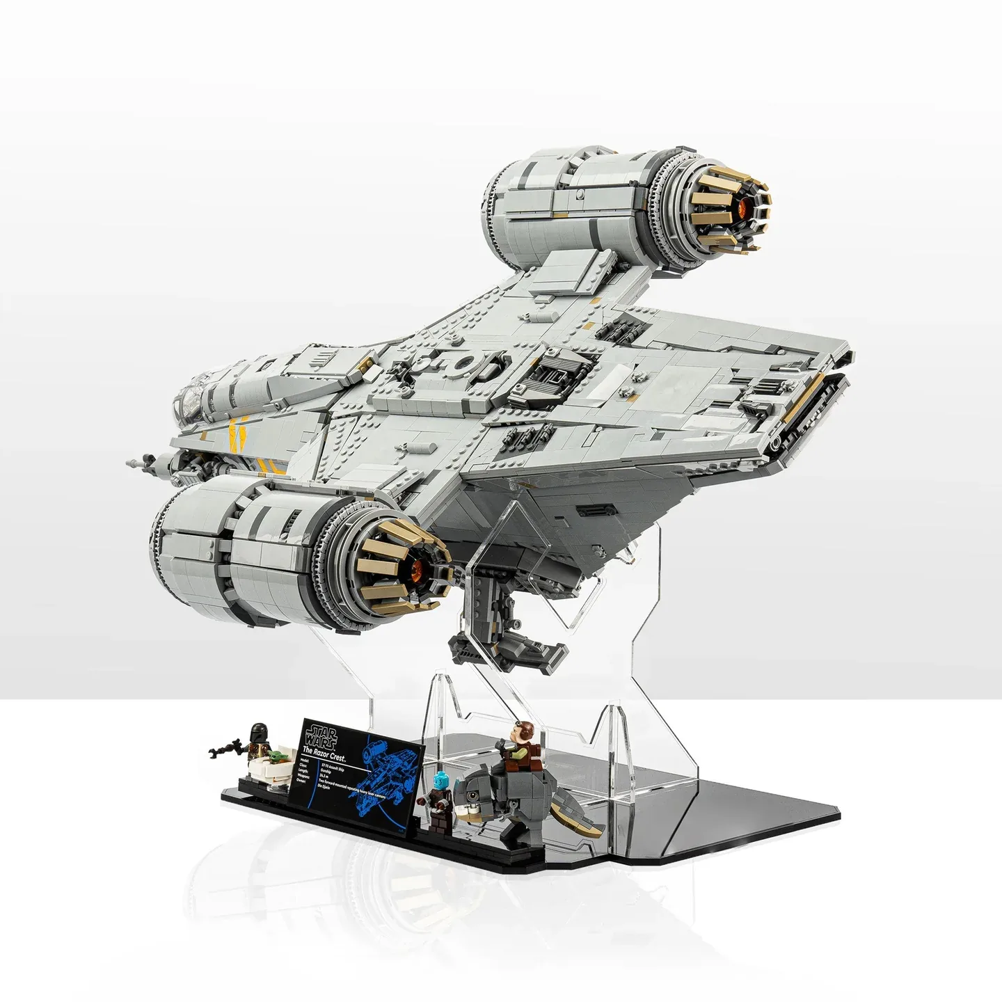 CubeBuff photograph of LEGO 75331 Razor Crest on an open clear acrylic support above a black base, with figures and plaque shown